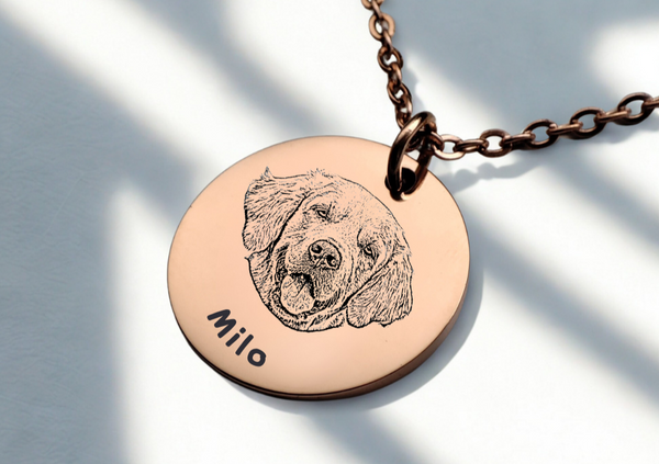 Rose gold necklace with a circular pendant featuring a engraved dog's face and the name 'Milo' on a light background.
